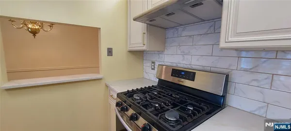 a stove top oven sitting inside of a kitchen