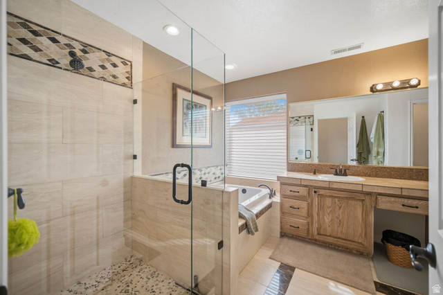 1985 West Rivers Edge Lane St. George, UT 84770 - Photo 23 of 42 Full bathroom with vanity, a shower stall, a bath, light tile patterned flooring, and recessed lighting