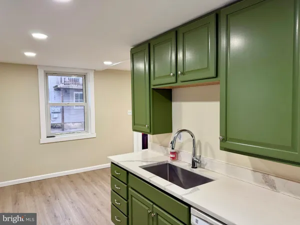 a kitchen with a sink and stainless steel appliances