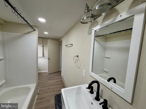 a bathroom with a bathtub and shower