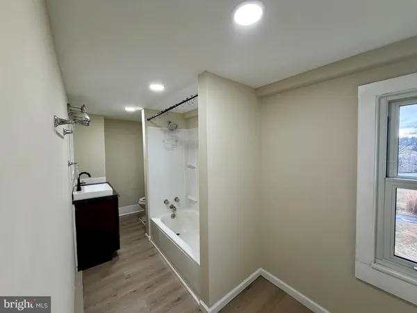 a bathroom with a bathtub and shower