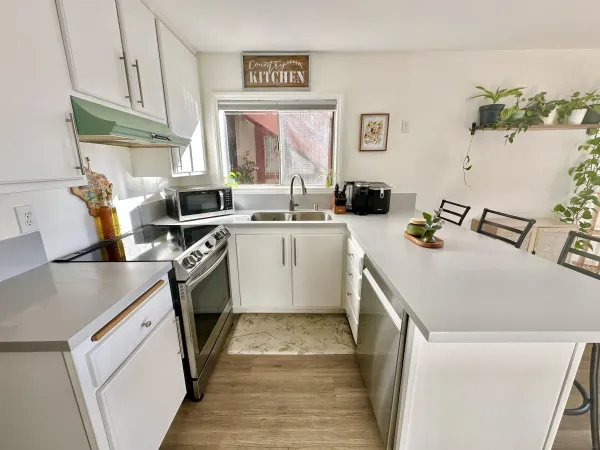 a kitchen with a sink a stove and cabinets