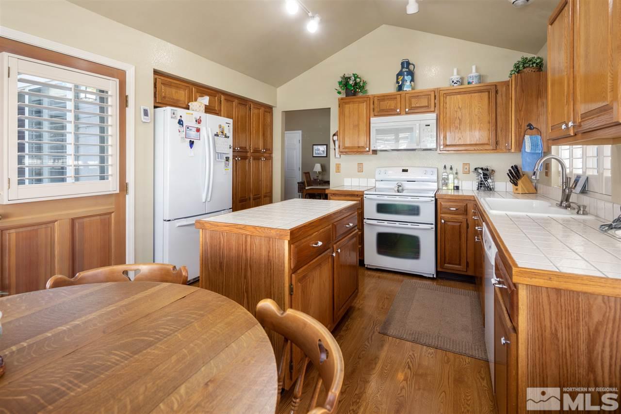 3345 Blackstone Court Reno, NV 89509 - Photo 12 of 29 a kitchen with a sink a stove a refrigerator and a window