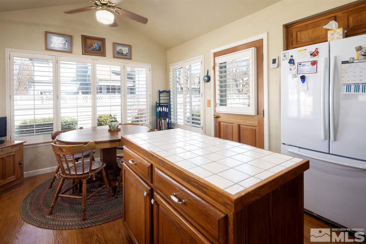 3345 Blackstone Court Reno, NV 89509 - Photo 13 of 29 a kitchen with a stove a refrigerator a sink dishwasher with a dining table and chairs