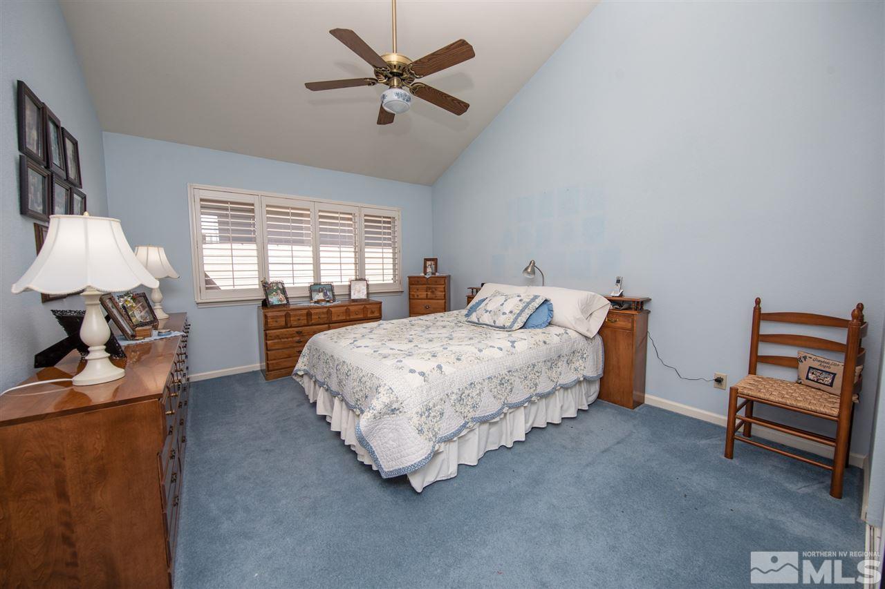 3345 Blackstone Court Reno, NV 89509 - Photo 15 of 29 a bedroom with a bed and a chandelier