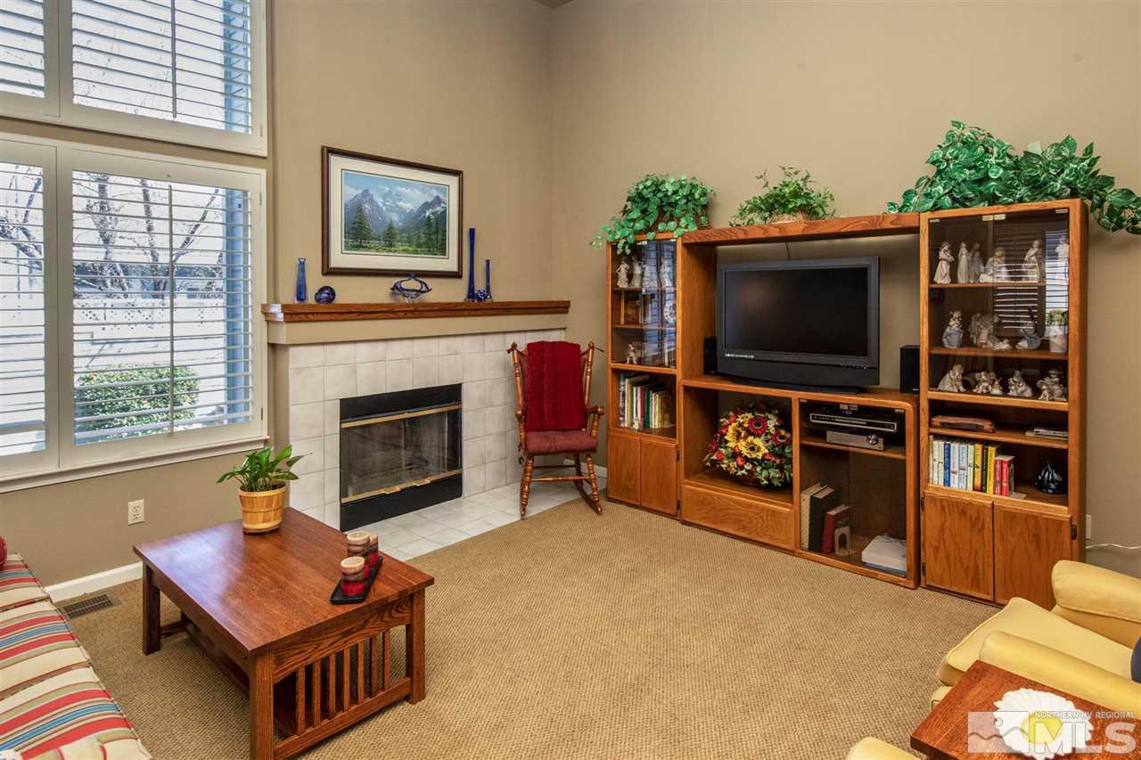 3345 Blackstone Court Reno, NV 89509 - Photo 6 of 29 a living room with furniture a flat screen tv and a fireplace