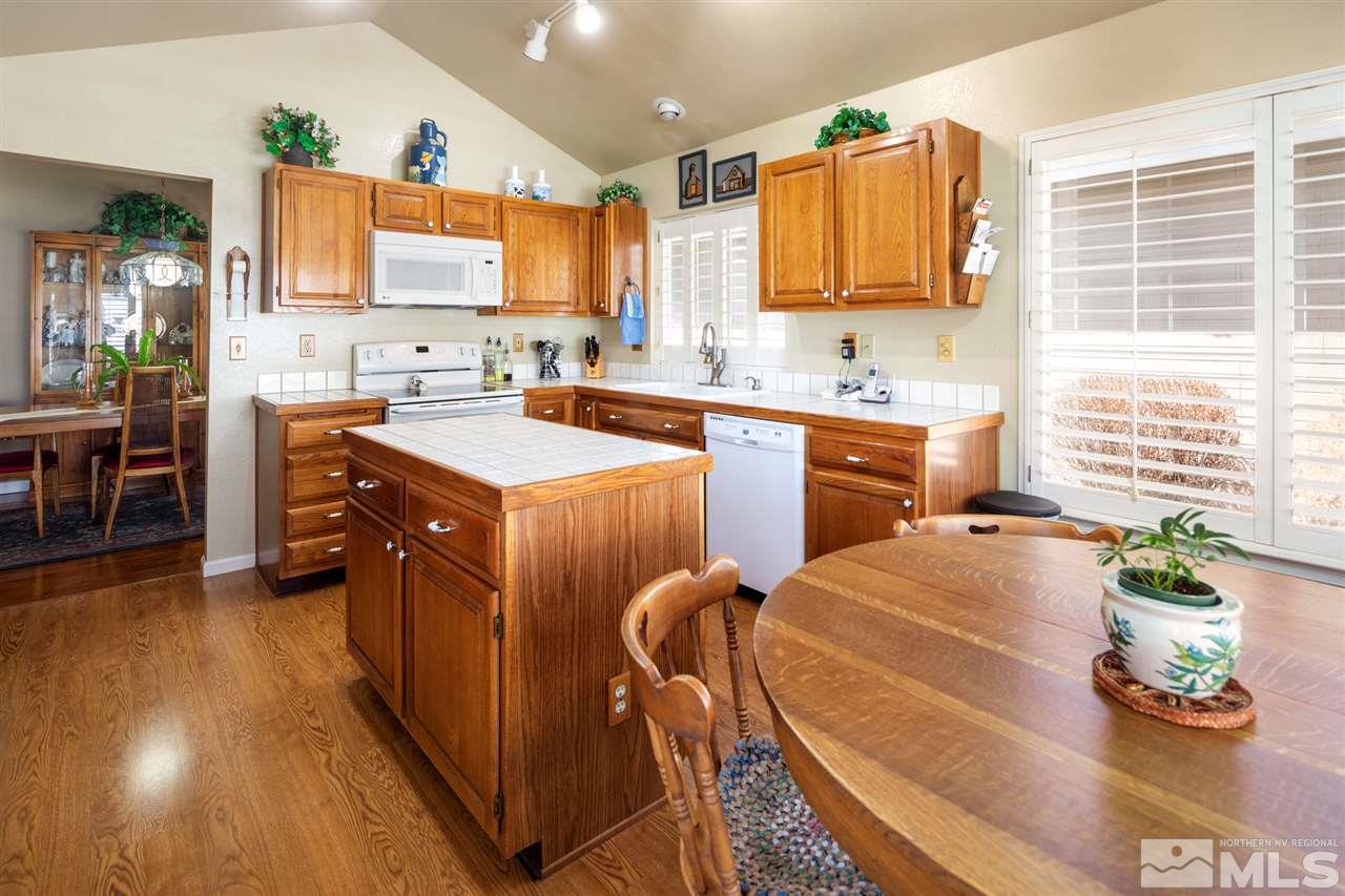 3345 Blackstone Court Reno, NV 89509 - Photo 10 of 29 a large kitchen with kitchen island granite countertop a sink a counter top space and stainless steel appliances