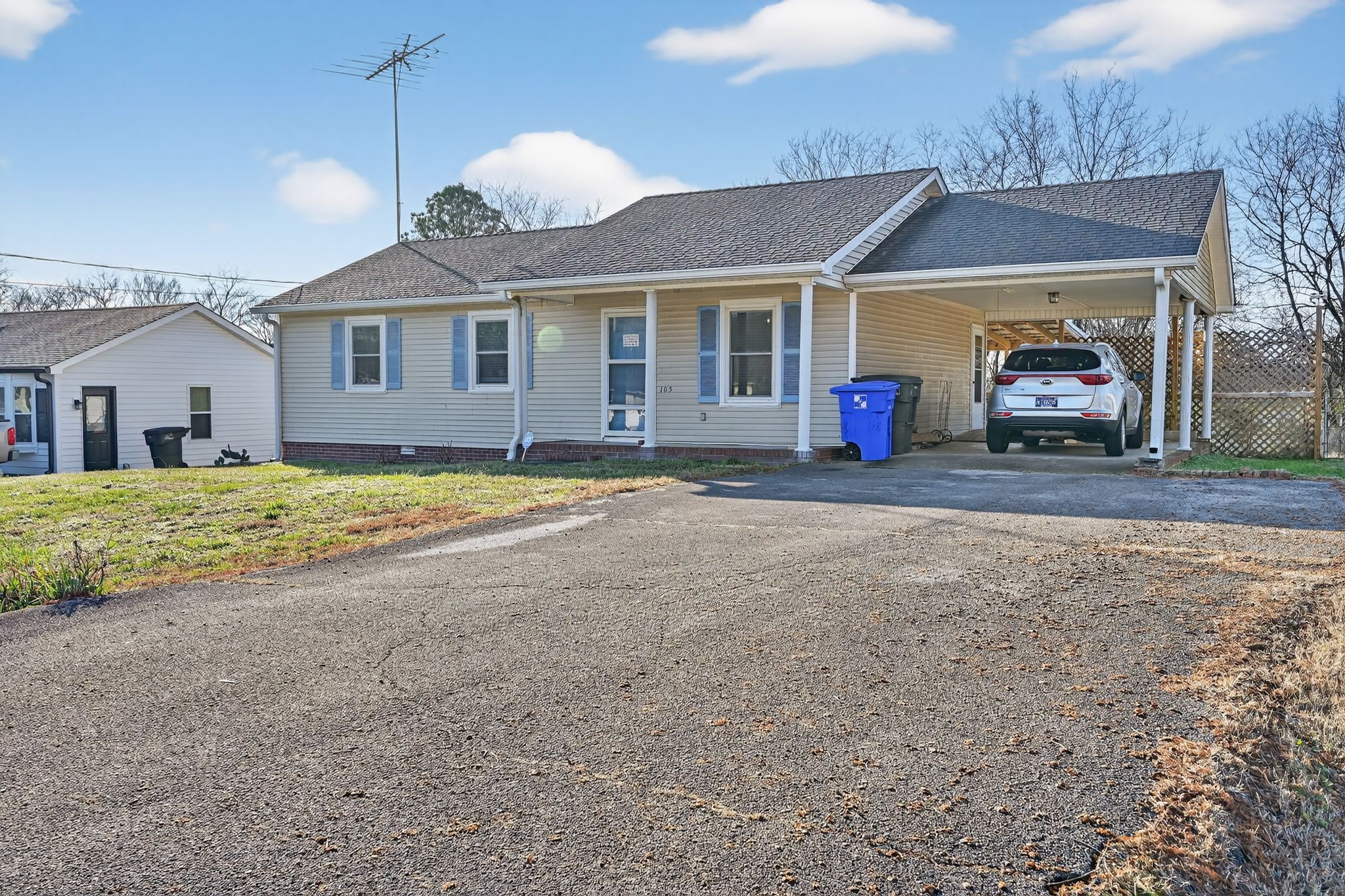 a view of a house with a large space and a car parked in front of it