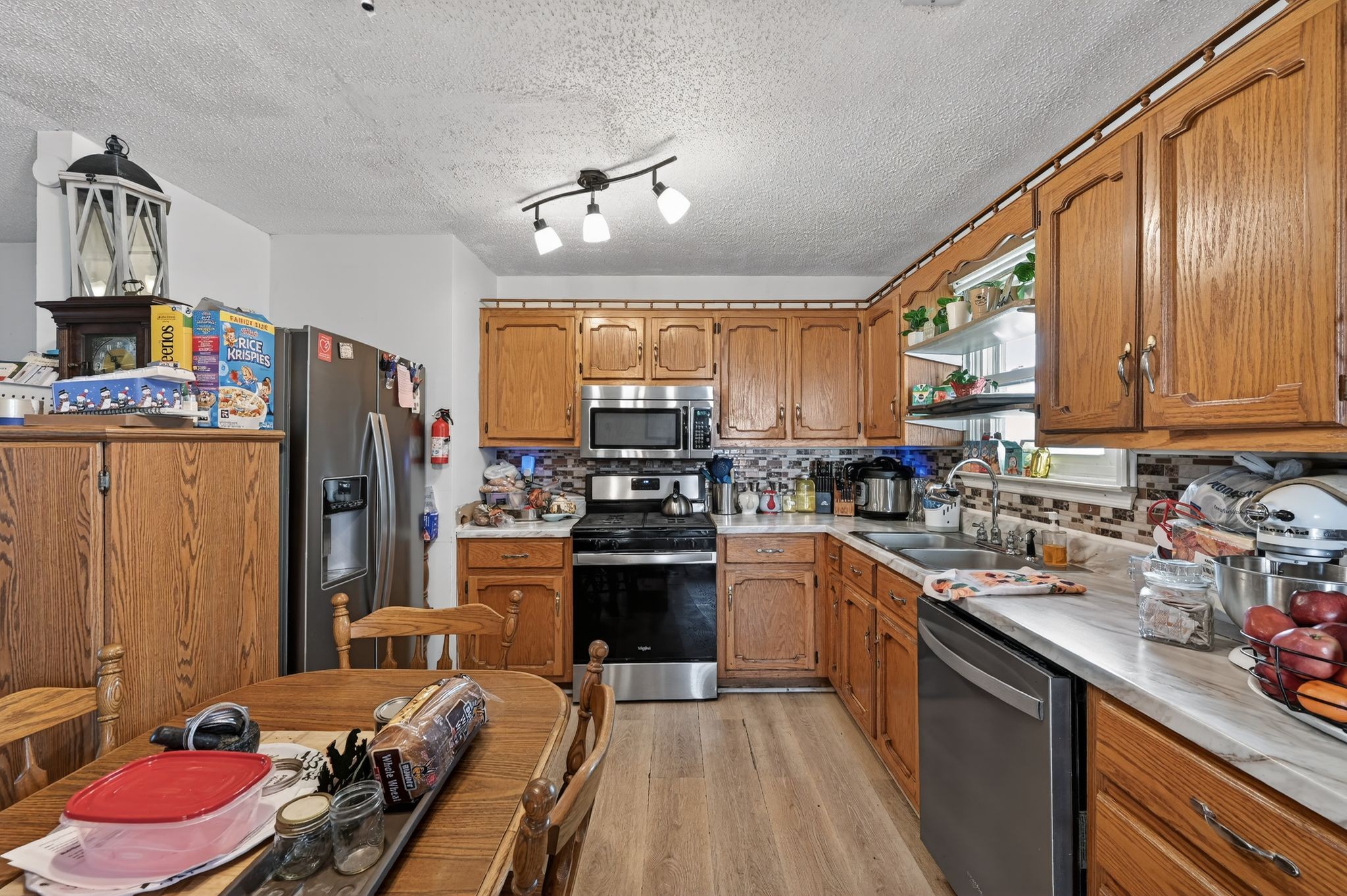 103 Reaves Cove Road Columbia, TN 38401 - Photo 13 of 24 a kitchen with stainless steel appliances granite countertop a sink dishwasher stove refrigerator and cabinets