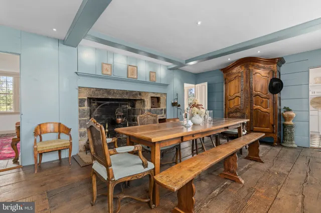a living room with furniture a fireplace and a table