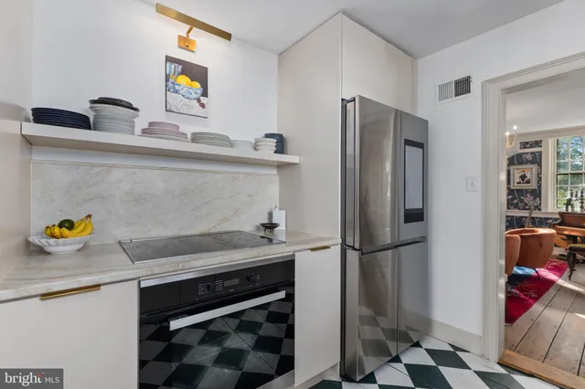 a kitchen with a refrigerator and a sink