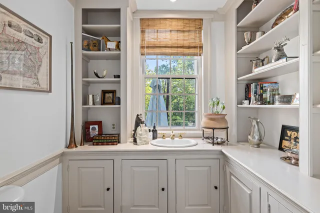 a kitchen with cabinets appliances and a window