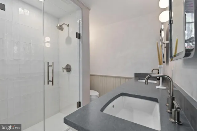 a bathroom with a sink and shower