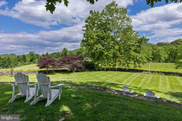 a swimming pool with outdoor seating and garden
