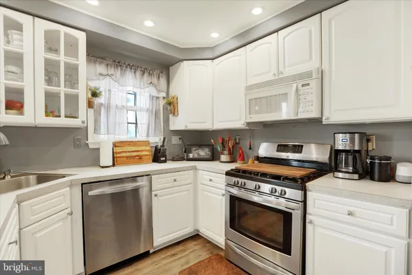 a kitchen with stainless steel appliances granite countertop a stove and a sink