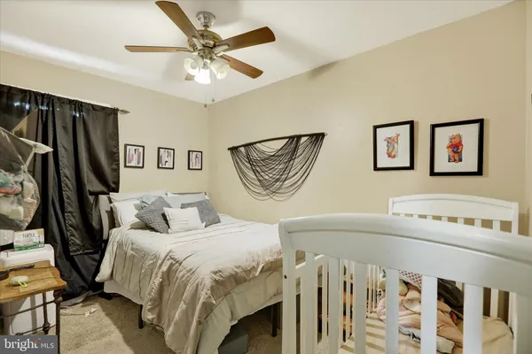 a bedroom with a bed a couch and a window