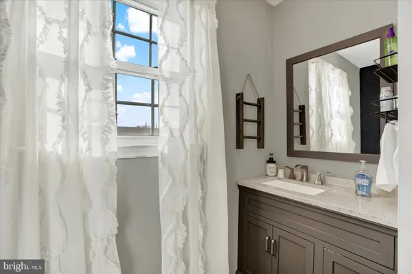 a bathroom with a sink vanity and mirror
