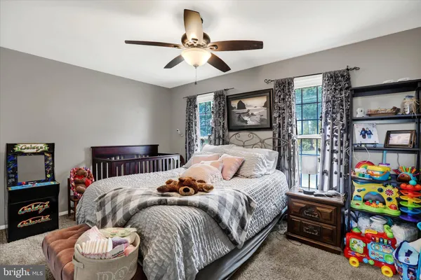 a bedroom with a bed furniture and a flat tv screen