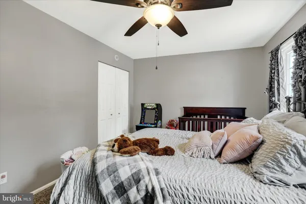 a bedroom with two beds and a chandelier