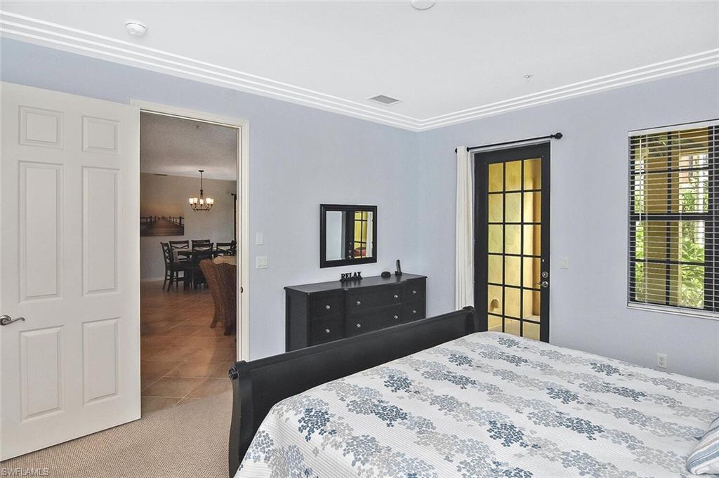 8949 Malibu Street, Unit 303 Naples, FL 34113 - Photo 14 of 50 a bedroom with a bed and a dresser