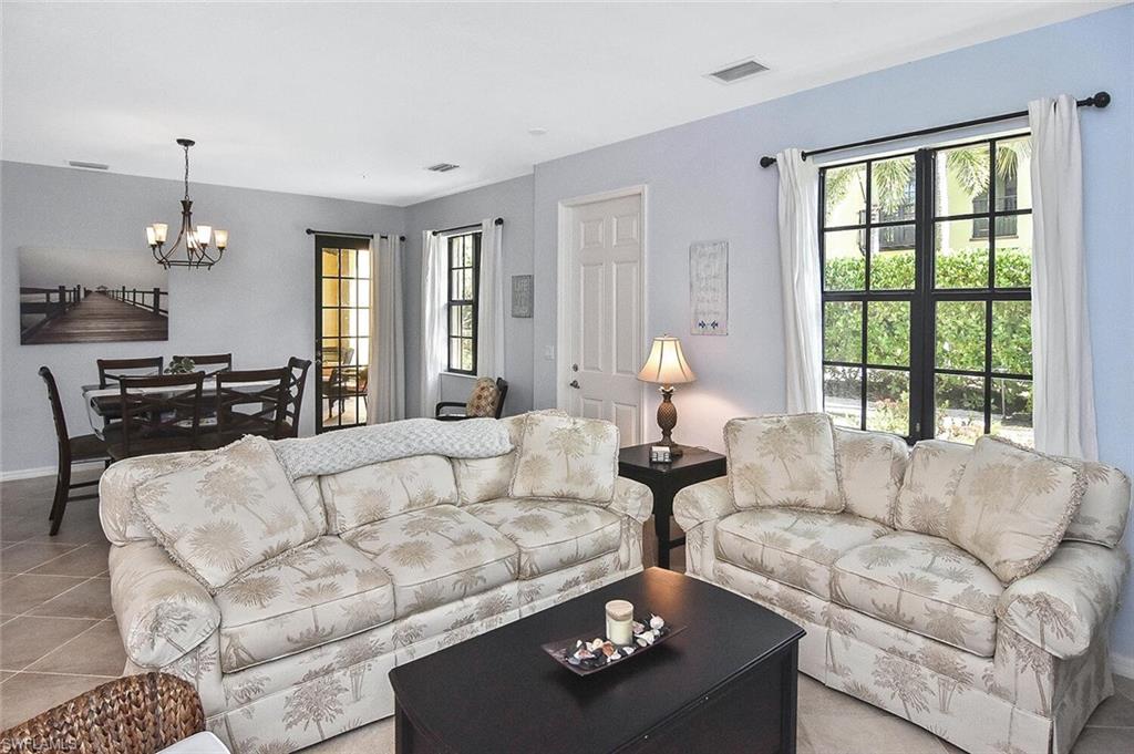 8949 Malibu Street, Unit 303 Naples, FL 34113 - Photo 15 of 50 a living room with furniture and a large window