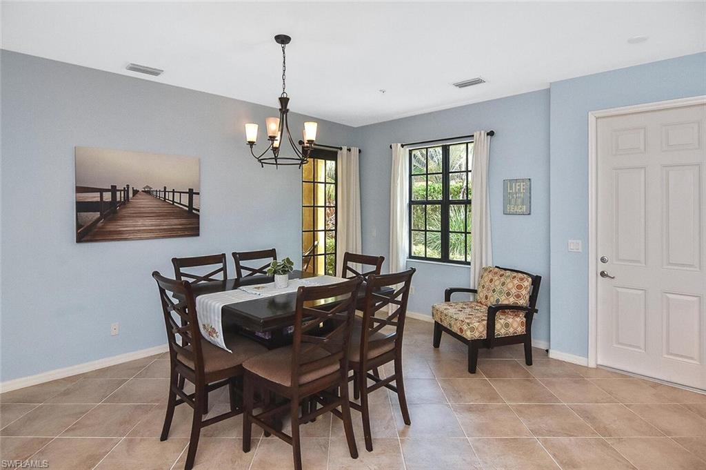 8949 Malibu Street, Unit 303 Naples, FL 34113 - Photo 16 of 50 a view of a dining room with furniture window and outside view