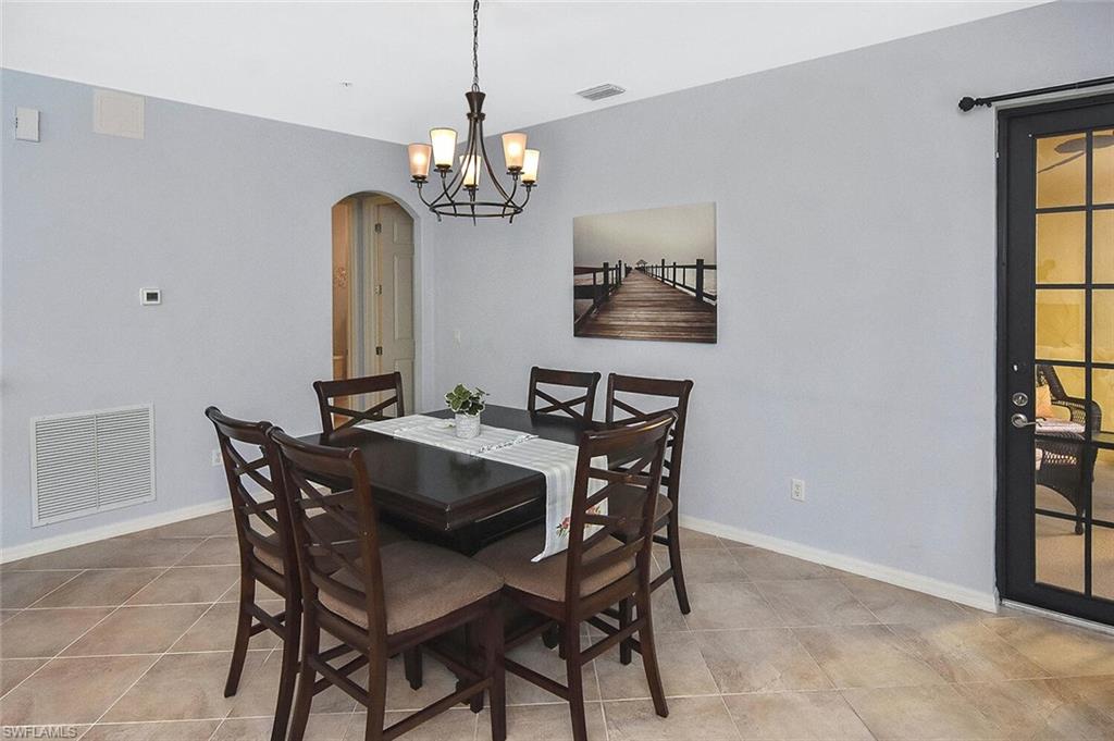 8949 Malibu Street, Unit 303 Naples, FL 34113 - Photo 17 of 50 a view of a dining room with furniture and a chandelier