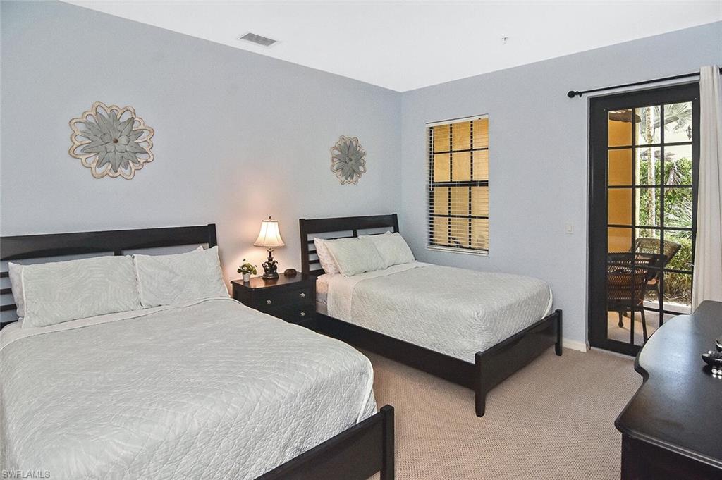 8949 Malibu Street, Unit 303 Naples, FL 34113 - Photo 20 of 50 a bedroom with two beds and a large window