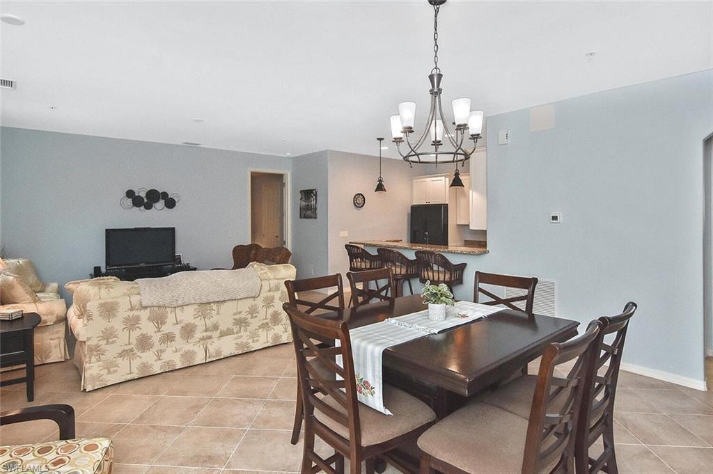 8949 Malibu Street, Unit 303 Naples, FL 34113 - Photo 25 of 50 a view of a dining room with furniture
