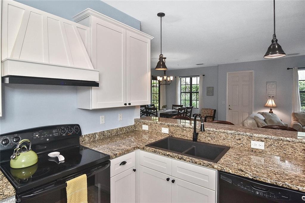 8949 Malibu Street, Unit 303 Naples, FL 34113 - Photo 31 of 50 a kitchen with a stove a sink and a refrigerator