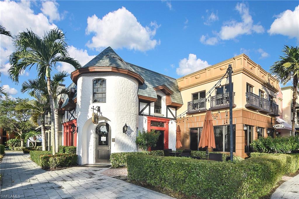 8949 Malibu Street, Unit 303 Naples, FL 34113 - Photo 38 of 50 a front view of a multi story residential apartment building with a yard