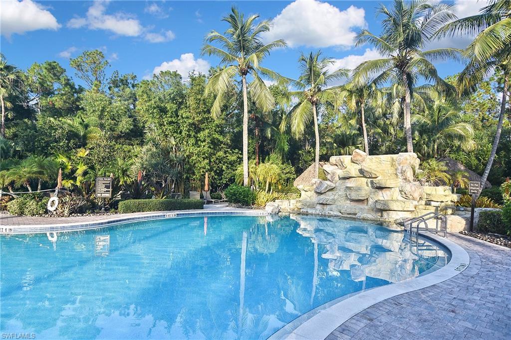 8949 Malibu Street, Unit 303 Naples, FL 34113 - Photo 44 of 50 a view of a swimming pool with a yard