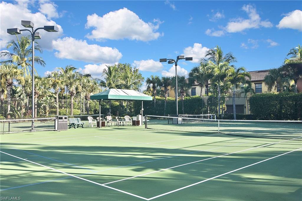 8949 Malibu Street, Unit 303 Naples, FL 34113 - Photo 48 of 50 a view of a tennis ground with large trees
