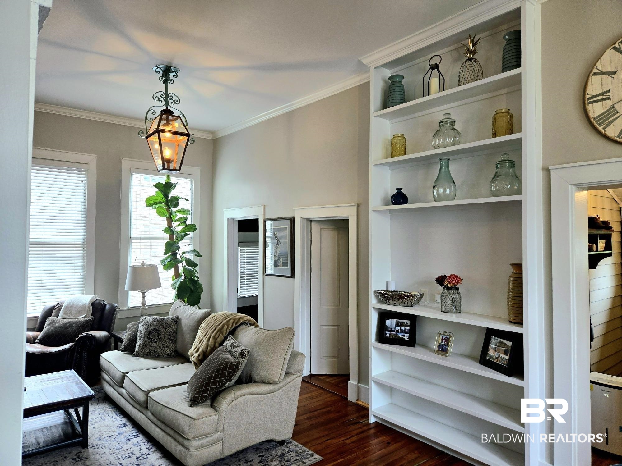 54 South Catherine Street Mobile, AL 36604 - Photo 15 of 55 Living area featuring dark wood-style flooring, crown molding, and built in shelves