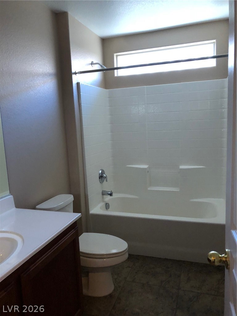 8962 Rutherford Grove Street Las Vegas, NV 89148 - Photo 11 of 16 Full bathroom featuring vanity, bathing tub / shower combination, and dark tile patterned flooring