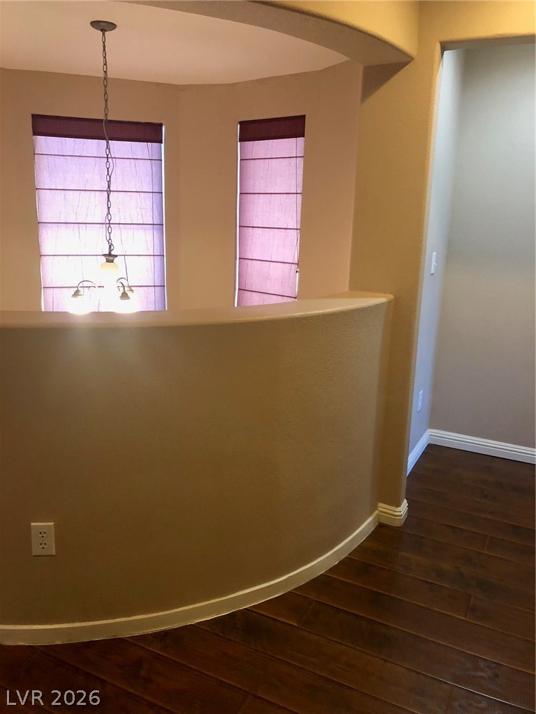 8962 Rutherford Grove Street Las Vegas, NV 89148 - Photo 13 of 16 Upstairs Hallway with dark wood-style flooring and baseboards