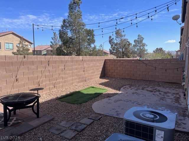 8962 Rutherford Grove Street Las Vegas, NV 89148 - Photo 15 of 16 Fenced backyard featuring an outdoor fire pit and a patio