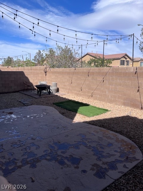 8962 Rutherford Grove Street Las Vegas, NV 89148 - Photo 16 of 16 Fenced backyard featuring a fire pit