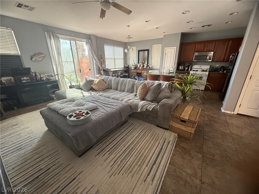 8962 Rutherford Grove Street Las Vegas, NV 89148 - Photo 5 of 16 Living room with a ceiling fan and recessed lighting
