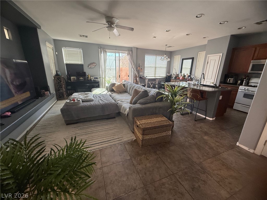 8962 Rutherford Grove Street Las Vegas, NV 89148 - Photo 6 of 16 Living area with a ceiling fan and recessed lighting