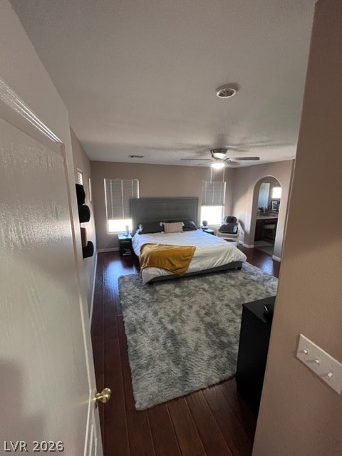 8962 Rutherford Grove Street Las Vegas, NV 89148 - Photo 7 of 16 Master Bedroom with dark wood-type flooring, a ceiling fan, and arched walkways