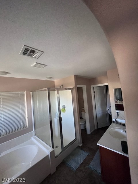 8962 Rutherford Grove Street Las Vegas, NV 89148 - Photo 9 of 16 Master Bathroom with vanity, a stall shower, a garden tub, and a textured ceiling
