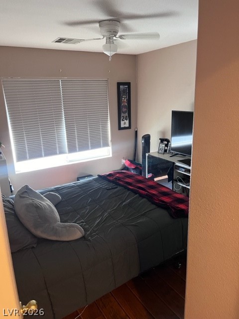 8962 Rutherford Grove Street Las Vegas, NV 89148 - Photo 10 of 16 Bedroom with dark wood-style flooring and ceiling fan
