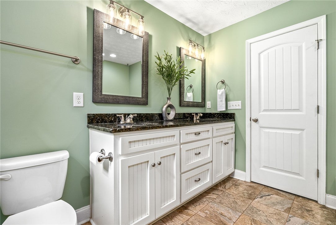 1284 Lee Road Salem, AL 36874 - Photo 13 of 24 This bathroom features a double vanity with granite counters and durable tile flooring.
