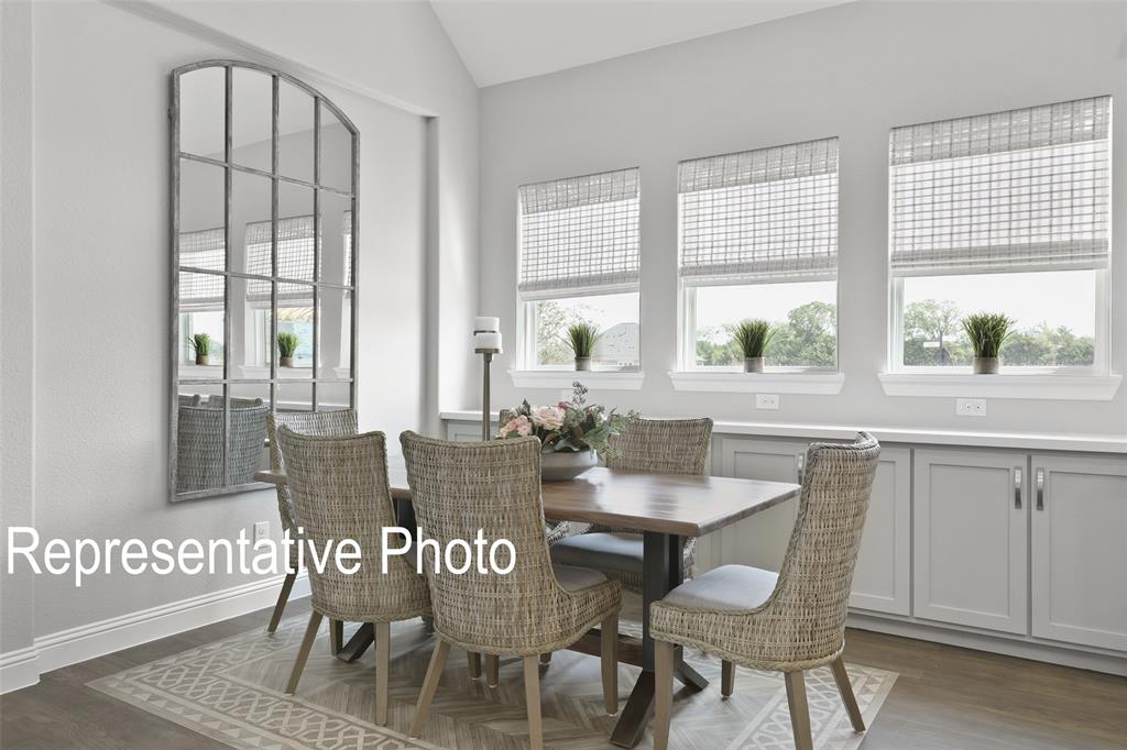 331 Fire Blade Drive Aledo, TX 76008 - Photo 6 of 17 Dining area featuring vaulted ceilings and a series of three windows