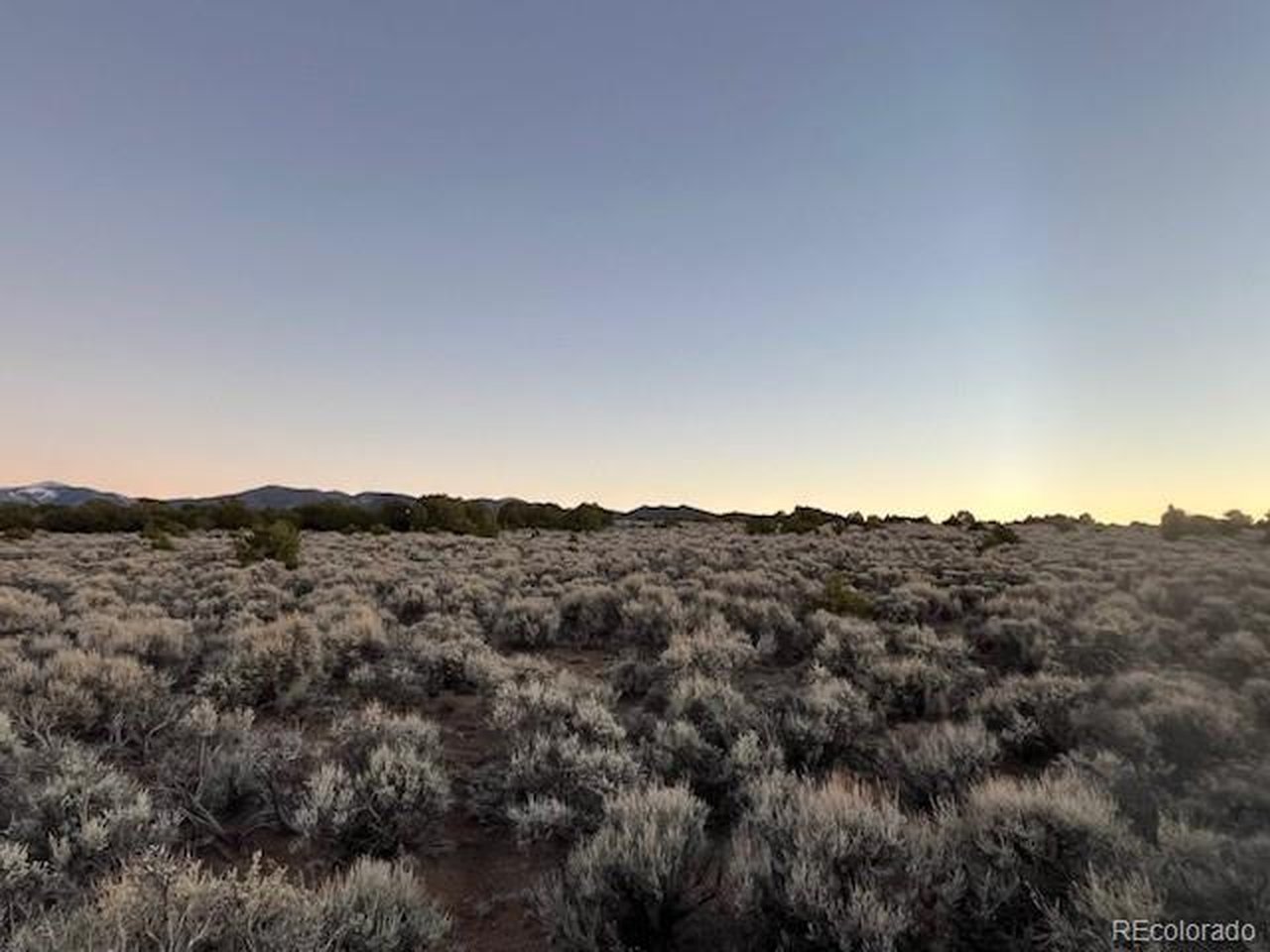 938 Bateman Road Fort Garland, CO 81133 - Photo 6 of 10 a view of a mountain in the distance in a field
