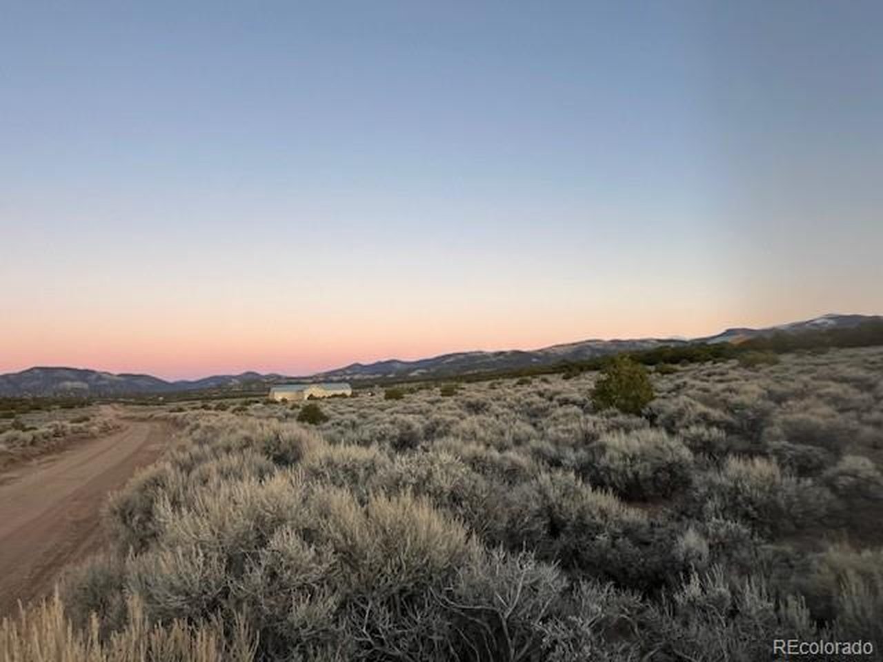 938 Bateman Road Fort Garland, CO 81133 - Photo 8 of 10 a view of a mountain range with trees in the background