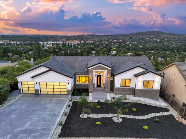 a aerial view of a house with a swimming pool and a yard