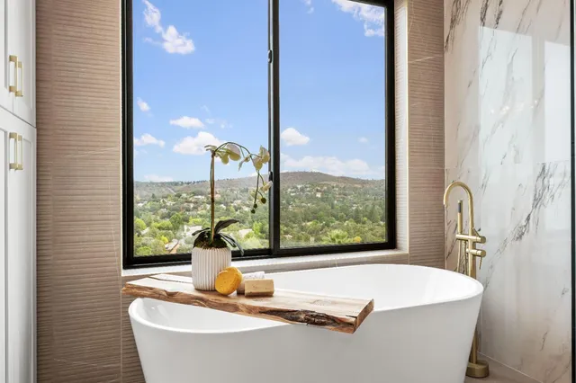 a bathroom with a granite countertop shower a toilet and a sink