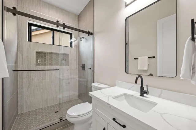 a bathroom with a sink toilet and shower